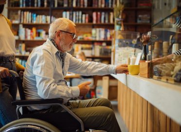 Handicapped older man and young female guardian