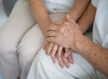 Old people holding hands each other